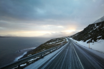 Route en bordure d'océan à la sorite de Siglufjordur, en islande à vélo en hiver